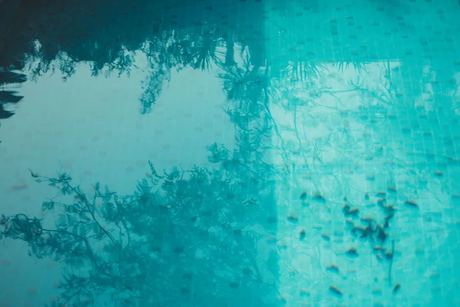Beautiful abstract reflection of trees in a serene turquoise pool.